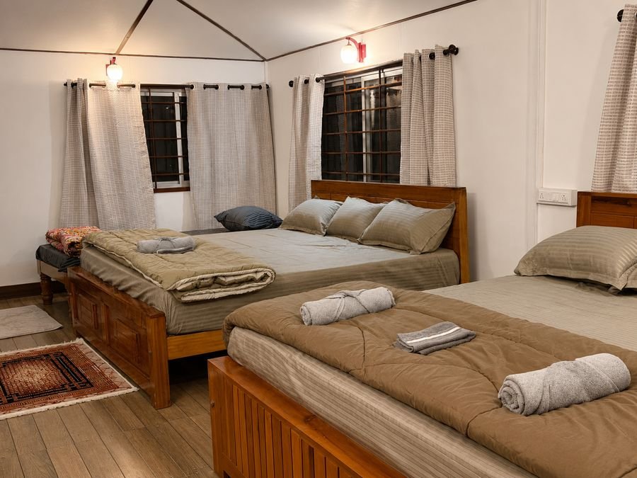 Cozy twin beds with warm lantern lighting at Sara Vintage Guest House